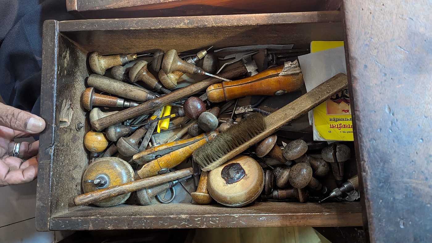 An open drawer of a traditional goldsmith's hand tools, punches and hammers in Goa
